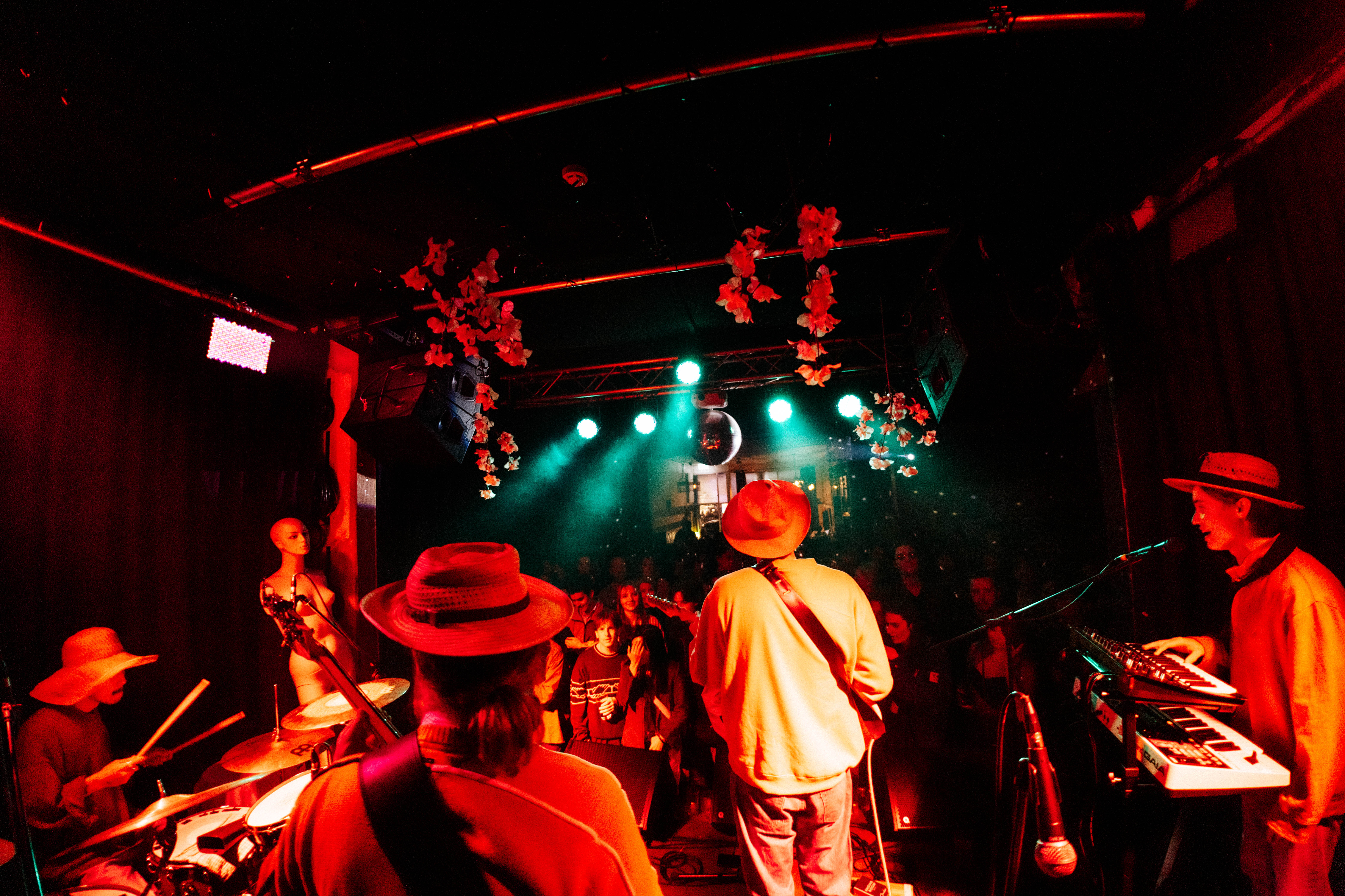 Guitarist performing on stage under vibrant stage lighting